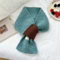 Blue knitted loop yarn scarf with contrast brown tie detail on a white linen bed - Lake Blue