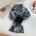 Detail view of leopard print knit scarf with black strap on white bed background - Grey Leopard