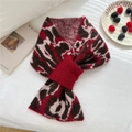 Detailed close-up of leopard print knitted scarf with cross-insert design on white background - Red Leopard