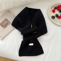 Detail of 100% wool knitted scarf showing wood toggle button and ribbed texture in black - Black