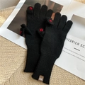 Close-up of black knit gloves with red heart embroidery and fold-back finger design - Black