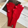 Detail of red knitted flip-top gloves with white heart embroidery and ribbed cuffs - Red
