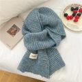 Blue knit scarf with mohair texture and Bonogeed label in a cozy winter setting - Striped Blue