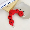Macro view of red wavy quilted bag handle accessory with black SANJIAYI embroidery - Red