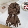 Brown knitted scarf with tassels and brand patch on a cozy white fabric background - 19*165cm / Brown