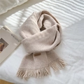 Soft beige knitted scarf with tassel fringe and handmade leather tag on white linen - Off White