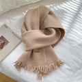 Knitted beige fringe scarf with handmade leather tag on a soft white background - Khaki