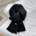 Classic black knitted tassel scarf with a brown handmade leather label on soft fabric - Black
