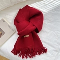 Solid dark red knit scarf with fringe and 'Hand Made' tag on white background - Red