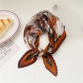 Pleated square silk scarf with brown and orange abstract floral print on a table - White Peony with Brown Border (Pleated 5)