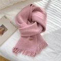 Pink knitted scarf with fringe and leather handmade tag on white bedding background - Light Pink