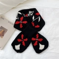 Detailed knit texture of a black scarf with bold red and white geometric star patterns - Black (Lucky Clover)