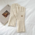 Detail of cream knit gloves featuring ribbed long cuffs and a decorative gold metal button - One Size / Cream