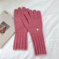 Close-up of pink knit gloves with long ribbed cuffs and elegant gold logo detail - One Size / Pink