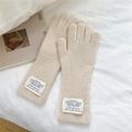 Macro detail of beige wool knit gloves showing woven brand label and ribbed cuff texture - One Size / Oatmeal Beige