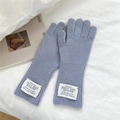 Detail of lavender wool knit gloves featuring ribbed cuffs and branded fabric labels - One Size / Blue and Purple