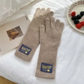 Close-up of brown knit gloves with reinforced cuffs and vintage textile brand label detail - Full Finger / Coffee