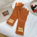 Detailed knit texture of orange thermal gloves with a woven winter bear patch label - Full Finger / Orange