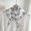Classic black and white paisley triangle scarf with delicate stitched hem for styling - White