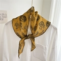 Mustard yellow paisley triangle scarf tied as a stylish headband and neck ribbon - Yellow