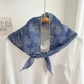Blue paisley print triangular scarf with wavy white lace trim on wooden hanger - Denim Blue
