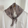 Taupe paisley triangular scarf tied on a white shirt collar with black wavy edges - Gray