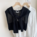 Close-up of black knitted hollow shawl with tie-knot and brand label on white shirt - 44*100cm / Hollow Arrow Fruit Tree Black