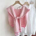 Detail of floral knit shawl with Pie apm label draped over a white shirt on hanger - Pink (Four-leaf Flower)