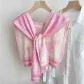 Close-up of pink knit shawl with floral jacquard and striped tie-up collar details - Pink (Sunflower)