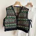 Close-up of ethnic woven vest shawl featuring colorful geometric patterns and black tassels - Green Plaid Triangle Embroidery / 46x46cm