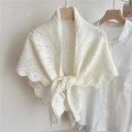 Detail of warm white openwork knit shawl tied over a white shirt on a wooden hanger - Milk White Heart Pattern Scalloped Edge
