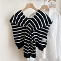 Detailed view of striped knit shawl with a knot design over a white shirt - Black Stripe