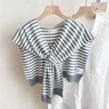 Detailed close-up of grey and white striped knitted shawl with logo label on white shirt - Grey and White Stripes