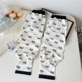 Detail of white cooling arm sleeves with black bow prints and elastic cuffs for sun protection - Line Bowknot (16 Simple-Line Bowknot)