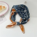 Pleated paisley silk scarf in navy blue and orange tied in a decorative ring shape - Orange Blue Paisley Border