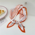 Pleated orange and white scarf with black FLOWER letter print in a knotted style - Orange FLOWER Pattern Border
