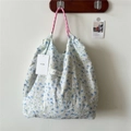 Detail of floral tote bag featuring drawstring rope handles and a Fanjia brand label - Yellow Blue Floral
