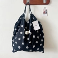 Detail of floral printed tote bag with pleated texture and stylish drawstring handles - Small Rose Black