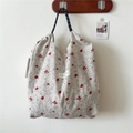 Detailed view of floral canvas tote bag featuring woven rope handles and red flower patterns - Red Spotted Flower Beige