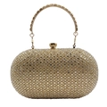 Close-up of golden clutch bag with shimmering rhinestones and a metal ring handle - Light gold