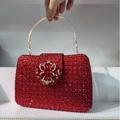 Detail of luxury red evening bag with encrusted rhinestones and gemstone flower - Red