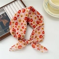 Floral print lightweight neck scarf tied in a bow with soft red and orange flower patterns - Dotted Red Yellow Flower