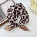 Foulard en soie imprimé léopard stylisé en bandeau à côté d'un magazine et d'un café - 5 Coton - Léopard Moelleux