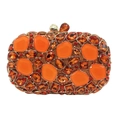 Detailed view of orange stone clutch bag with crystal embellishments and gold leaf clasp - Orange