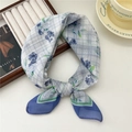 Breathable square scarf featuring blue and green floral plaid patterns on a wooden tray - Blue Floral Plaid Blue Edge