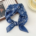Dark blue linen silk square scarf featuring white floral patterns tied in a knot - Three-Leaf Hollow Flower Blue