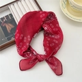 Elegant red floral silk scarf with geometric patterns tied in a stylish ribbon knot - Motorcycle Chain Red