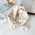 Chic cream floral cotton linen scarf tied in a bow with vibrant orange flower patterns - Off-White Orange Red Floral (6 Cotton - Falling Red)