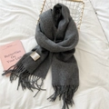 Detail of dark grey 100% wool scarf with handmade fringes on a cozy white bed - Tassel Style / 46*195cm / Dark Gray