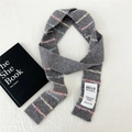 Close-up of grey knit scarf featuring colorful tassel stripes and brand label detail - 6*175cm / Grey Knitted with Colorful Stripes